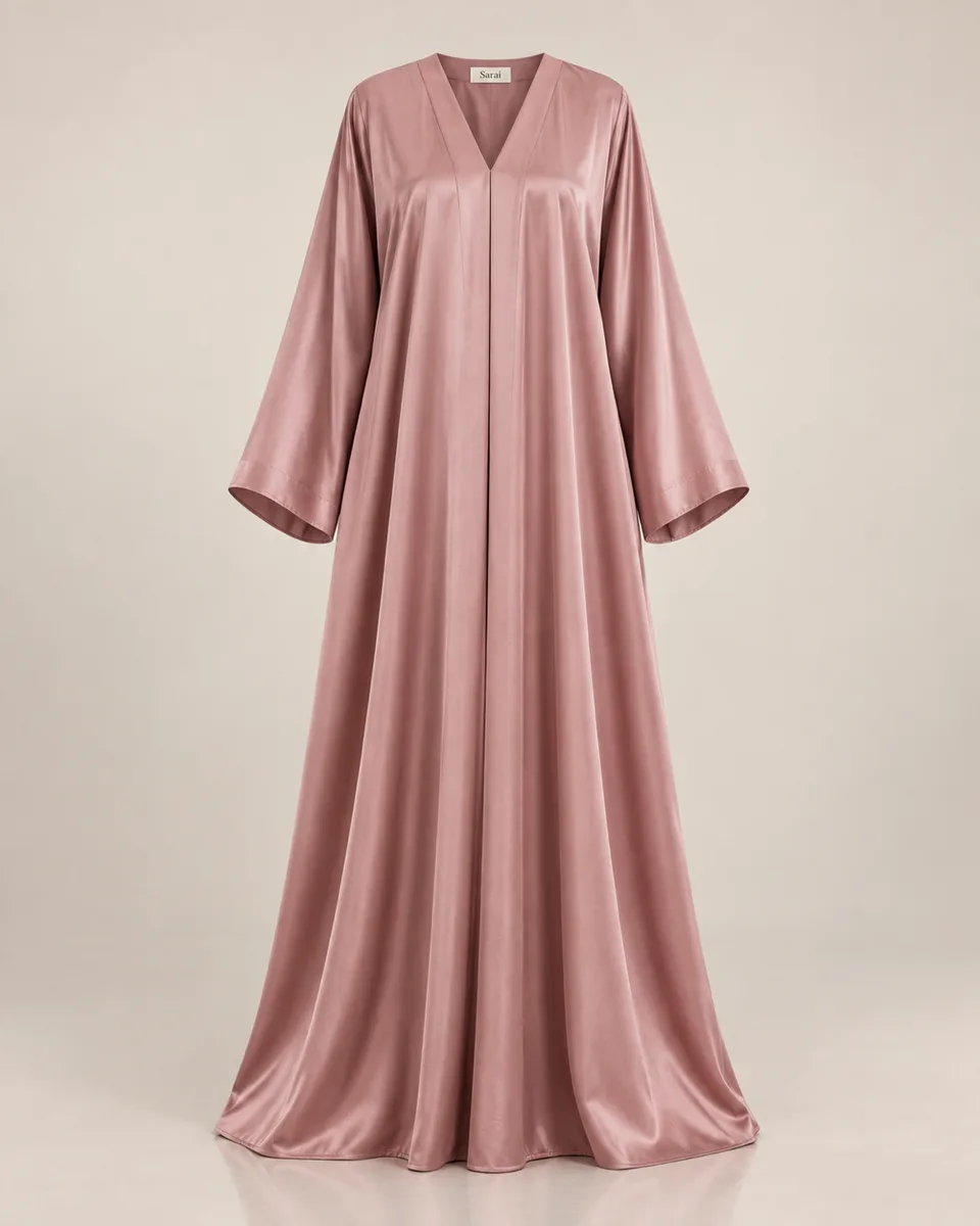 Gamis {{product}} {{brand_name}} tampak depan gaya ghost mannequin di latar {{primary_color}} lembut, jatuh kain terliha